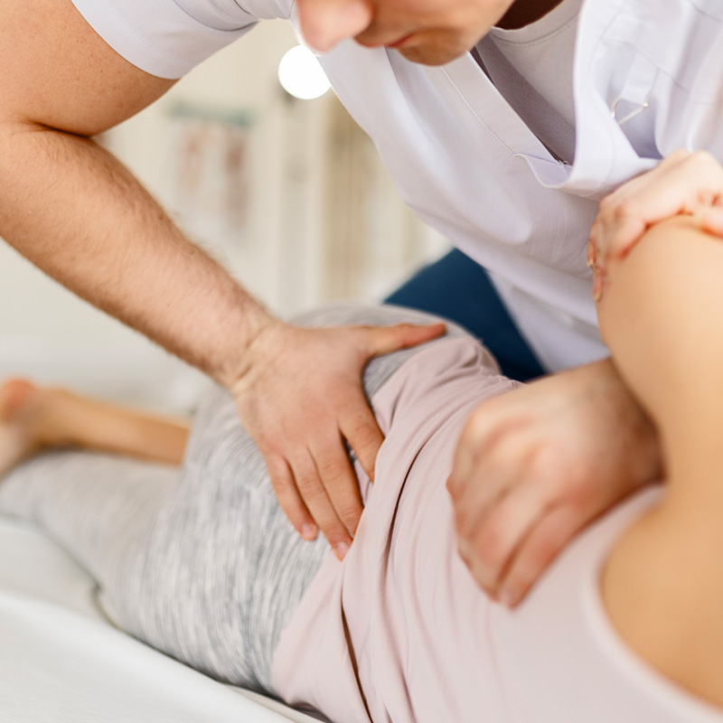 Female patient with chiropractor having back pain