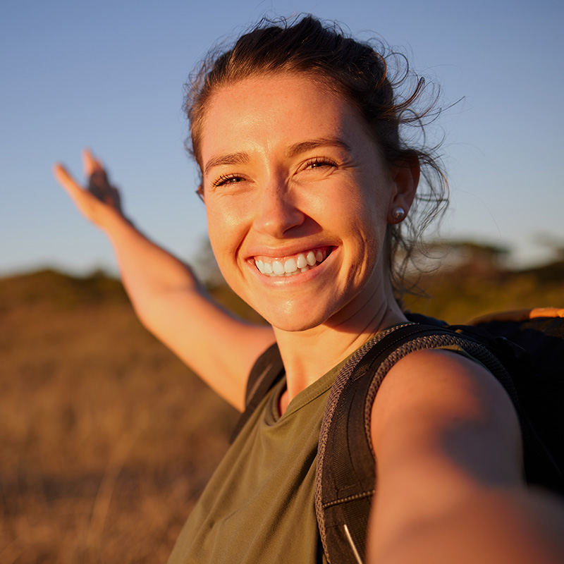 Shot of a young woman taking a selfie while out hiking
